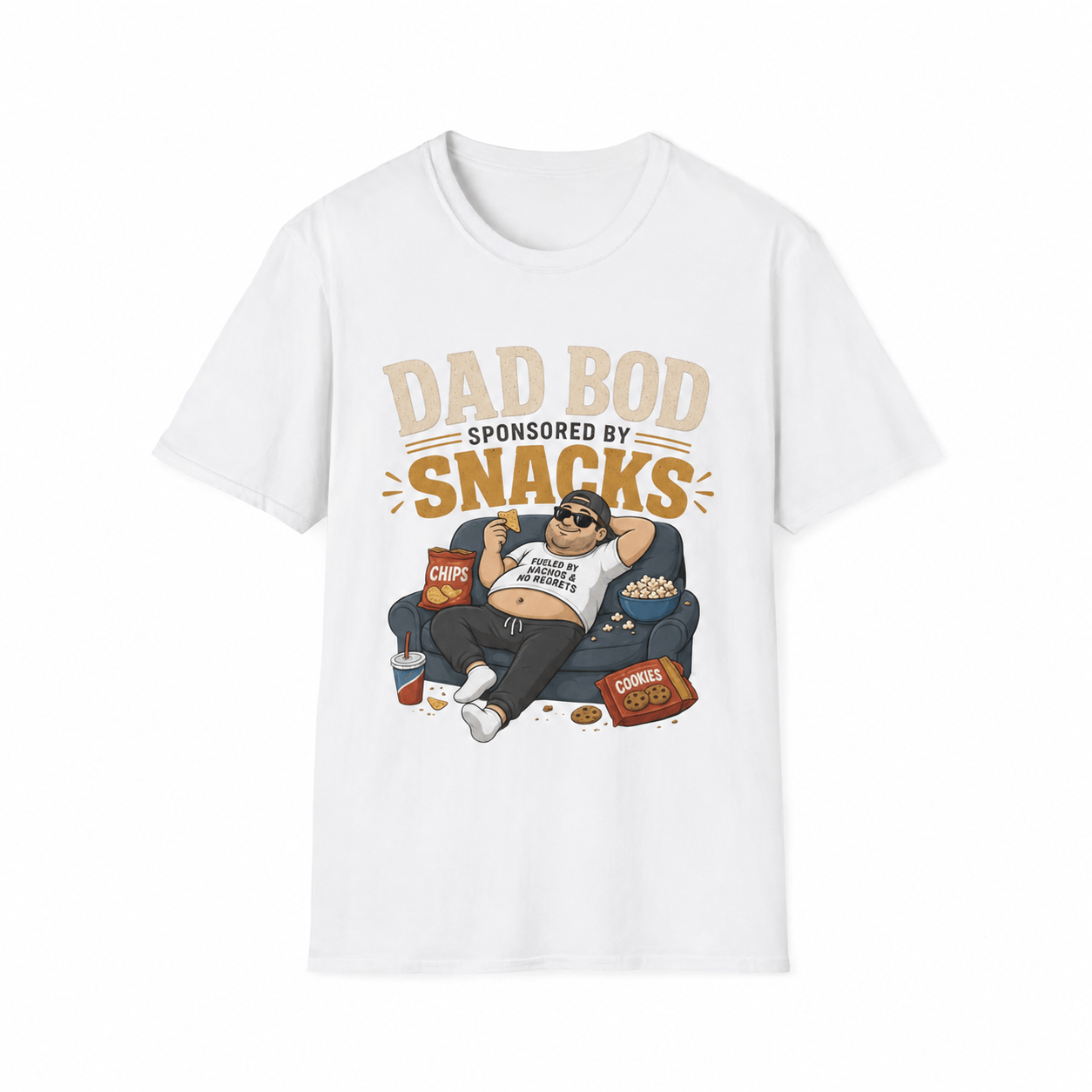 A white short-sleeve crewneck t-shirt featuring a cartoon graphic of a man lounging on a couch surrounded by snacks, with the text 'DAD BOD SPONSORED BY SNACKS' printed above him.